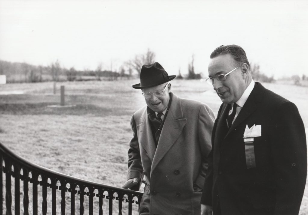 Dwight Eisenhower and Ken Wells entering the Martha Washington building for a board meeting.