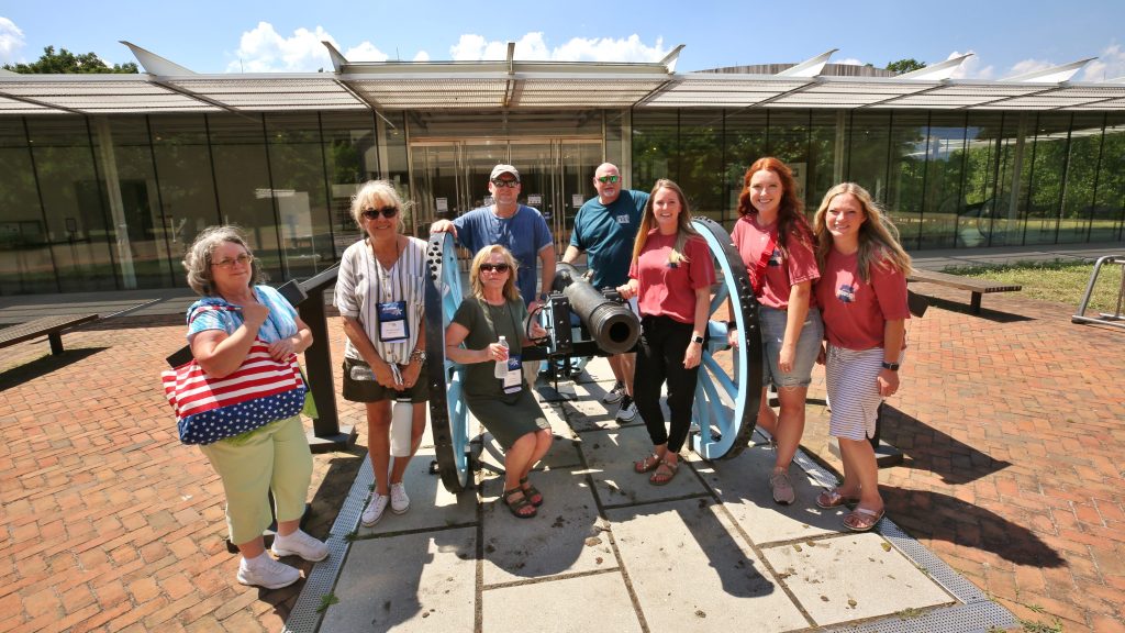Teacher group posing with cannon