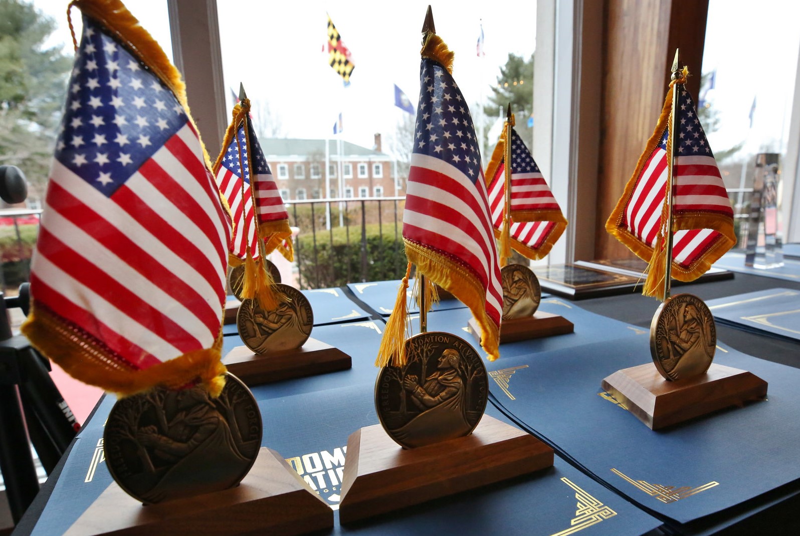 George Washington Medal awards displayed on a table with American flags