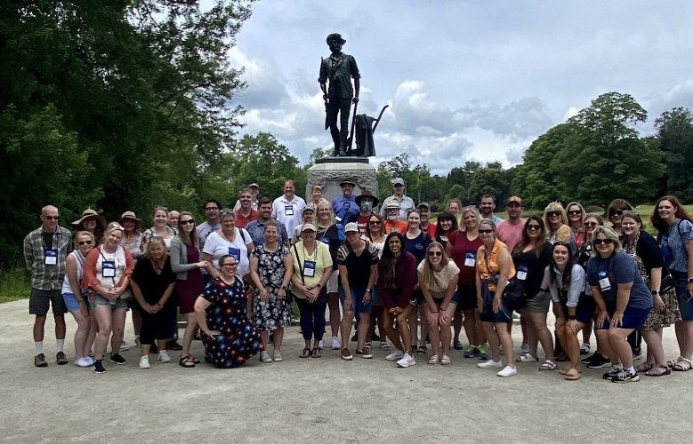 Teachers and Students group picture in front of statue at Valley Forge