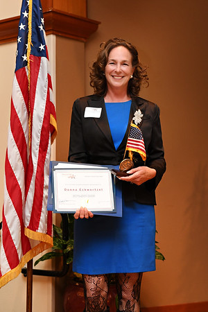 Donna Eckwortzel, winners of the National Award George Washington Medal of Honor posing with their trophy and certificate