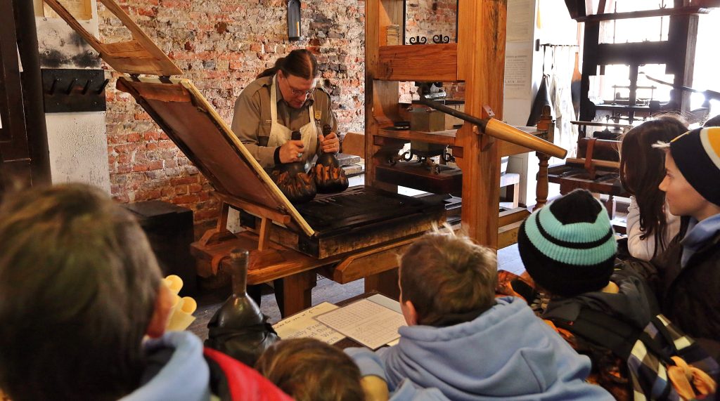 Students watching a Blacksmith