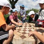 Students playing wooden checkers