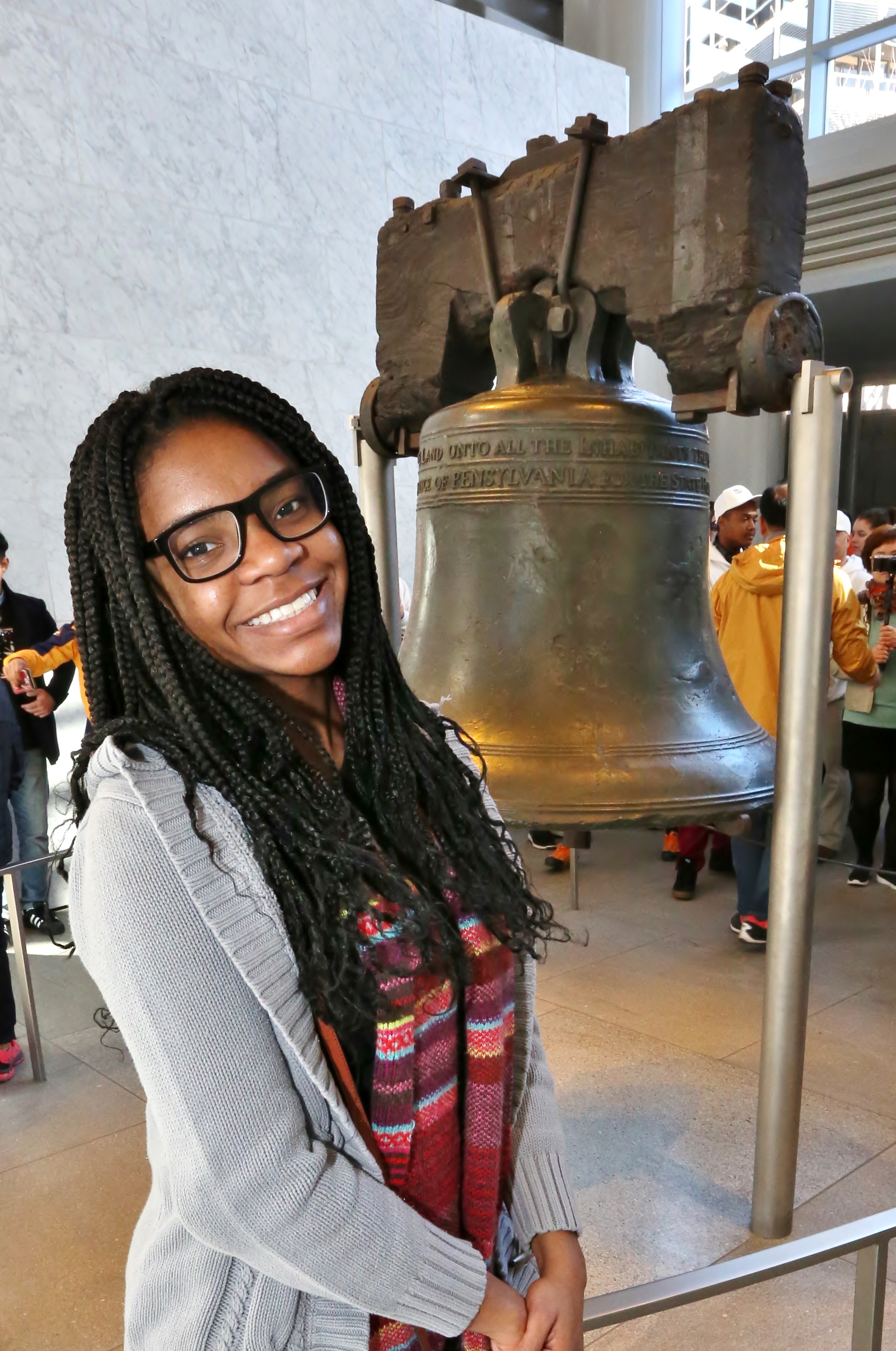 Student posing, smiling in front of Liberty Bell Philadelphia.  