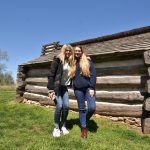 Students posing infront of log cabin at Valley Forge